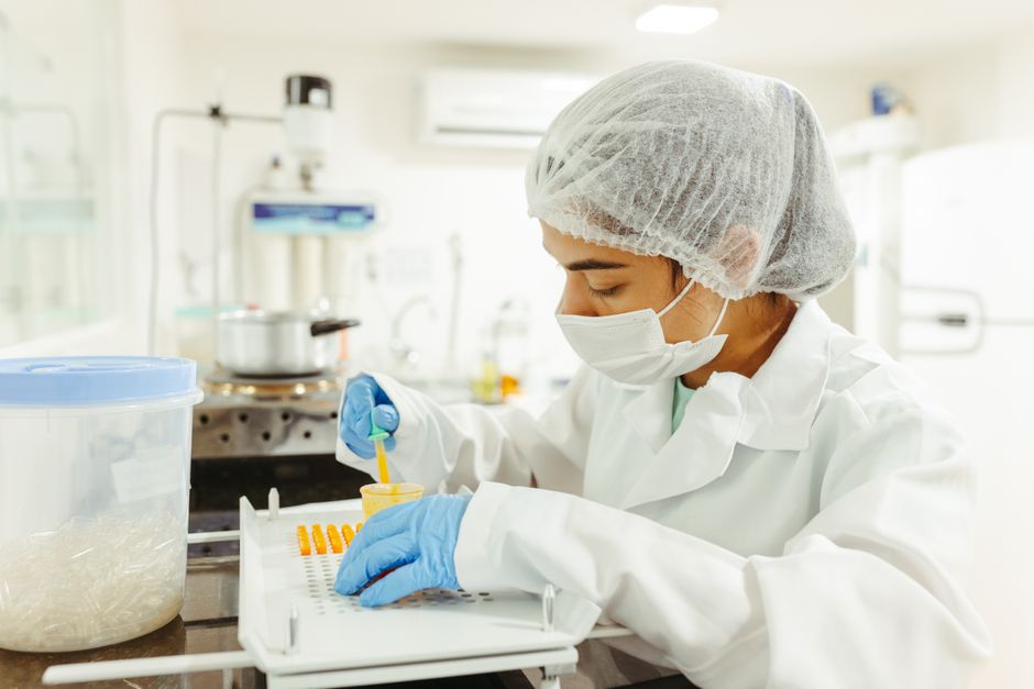 A researcher in a lab measuring a small sample, representing ongoing food allergy research