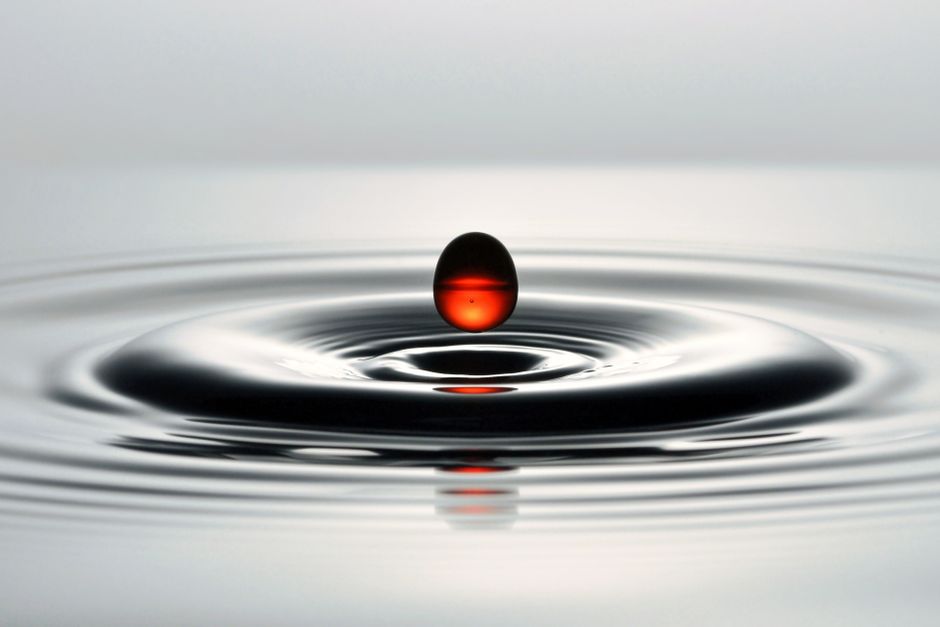 A single drop falling, representing the small daily dose used in sublingual immunotherapy